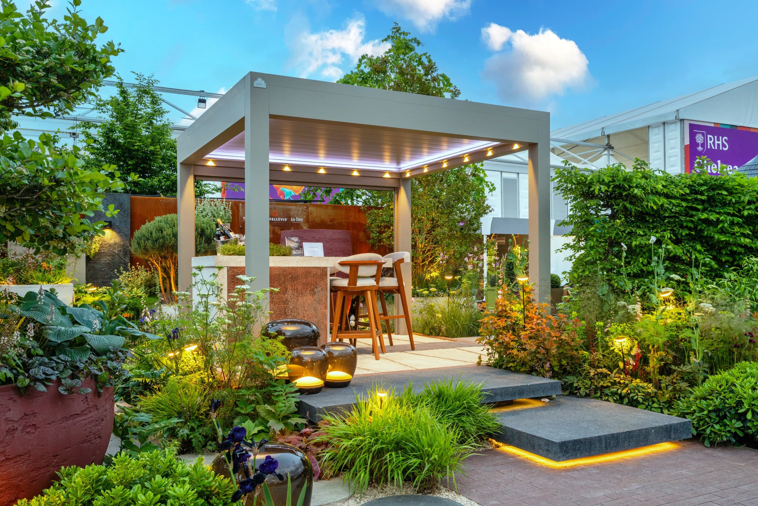 Ottorigo pergola terrace at dusk with integrated heaters and LED lighting
