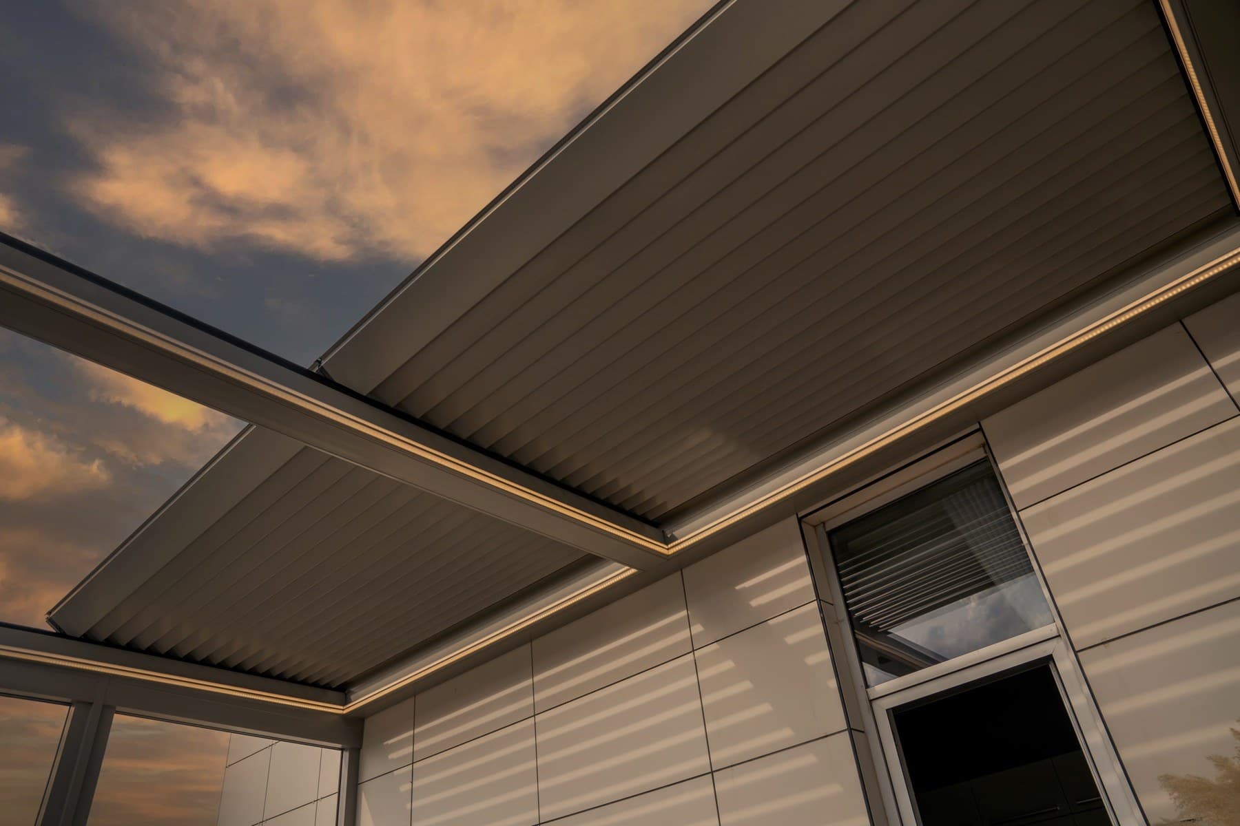 Ottorigo bioclimatic pergola at dusk with integrated LED lighting along the louvres